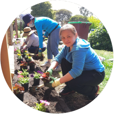 A volunteer planting flowers